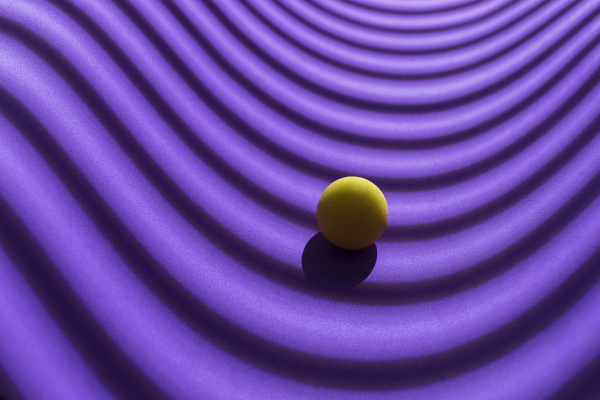 yellow sphere over a geometric purple