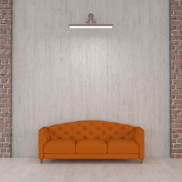 orange couch under wall lamp