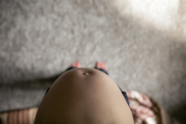 low section of pregnant woman standing