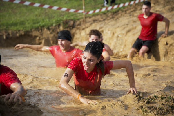 team crossing mud pit during race