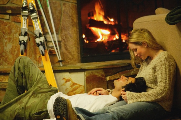 couple relax by fireplace