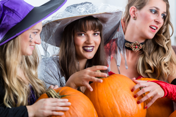 Three beautiful women acting as witches joining their - Stock Photo ...