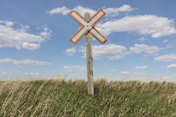 railroad caution sign on prairie