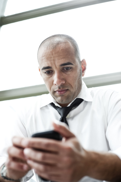 a middle eastern businessman texting on