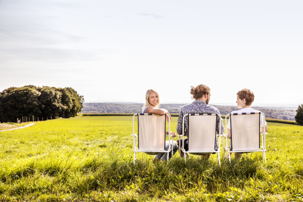 friends sitting on camping chairs in