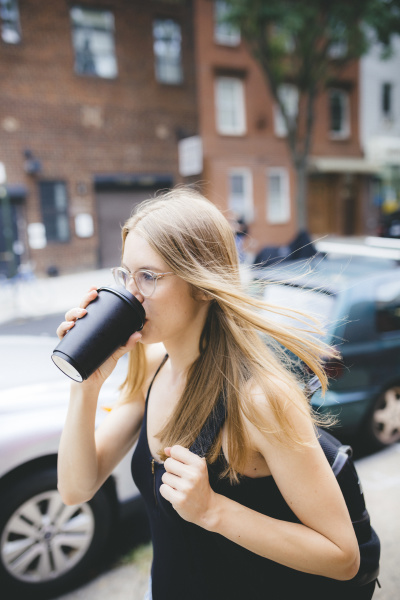 young woman drinking cup of coffee