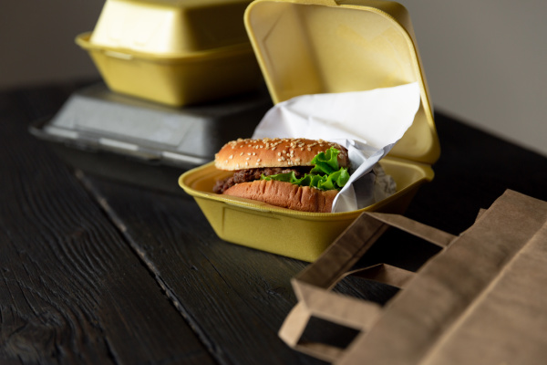 hamburger in a takeaway container on