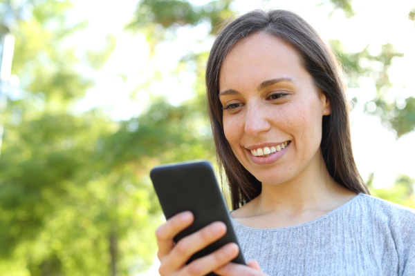 happy woman checking smart phone message