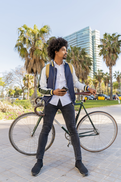 casual businessman with bicycle and cell