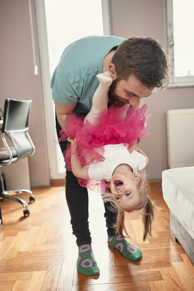 father and daughter playing at home