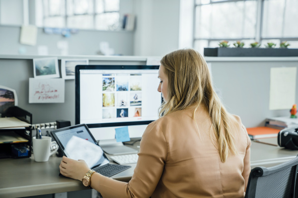 woman using digital tablet and computer