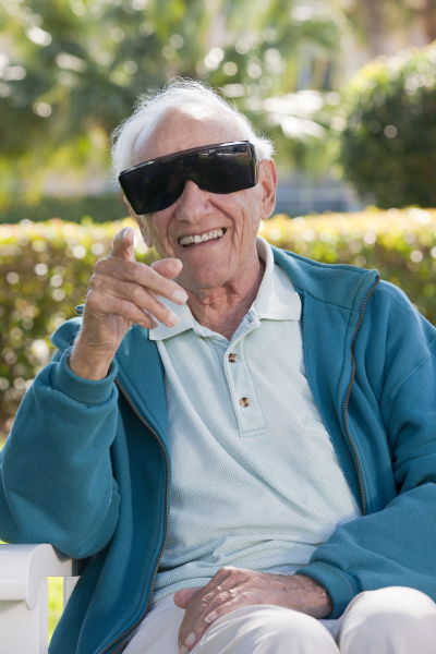 senior man wearing cataract dark glasses