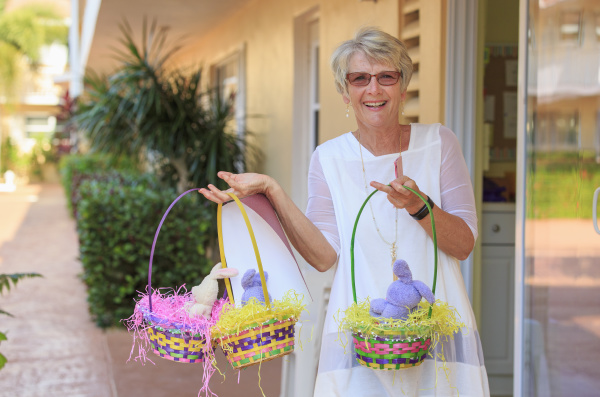 happy senior woman with easter baskets