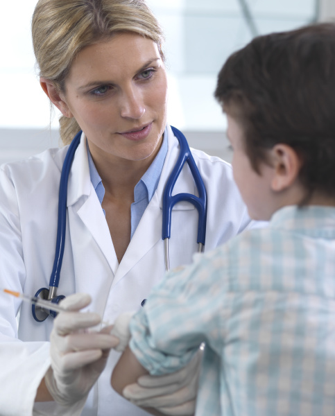 female doctor giving a young boy