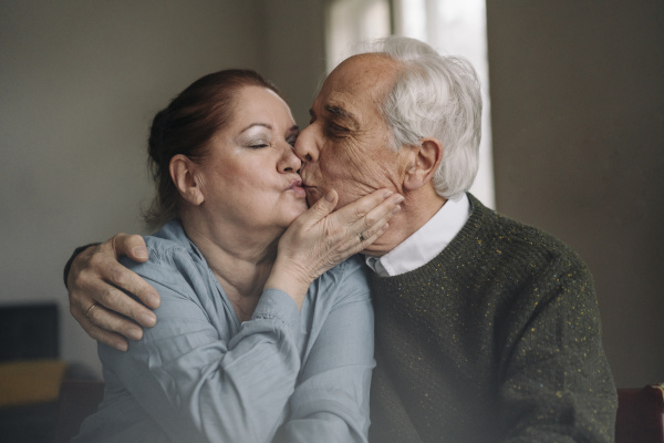 senior couple kissing at home