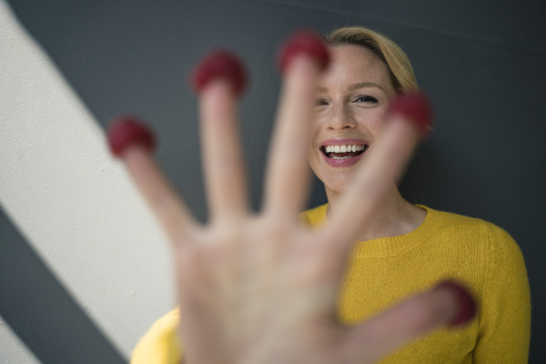 blond woman with raspberries on her