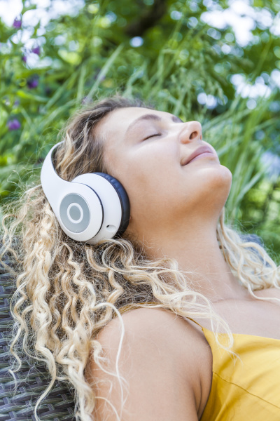smiling woman listening to music with