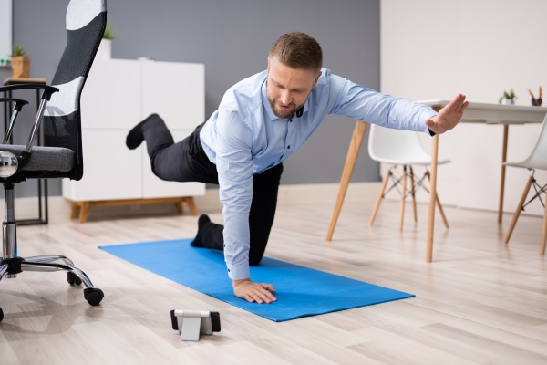 businessman doing stretching workout using smartphone
