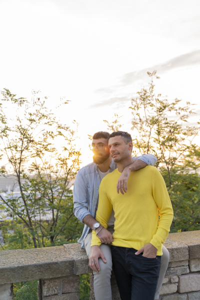 affectionate gay couple outdoors at sunset