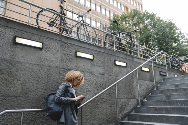 woman using smartphone at the entrance