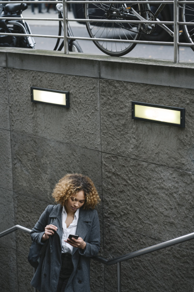 woman using smartphone at the entrance