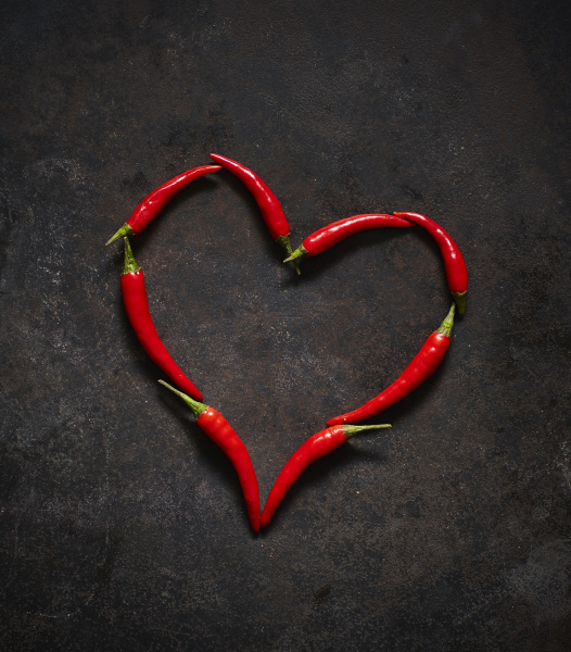red chili peppers arranged in heart