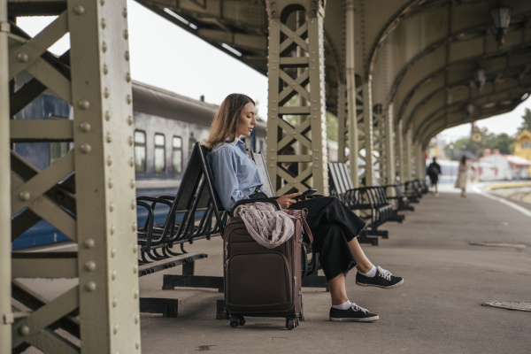 young female traveller waiting on train