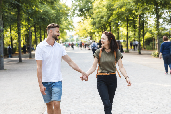 happy young couple walking hand in