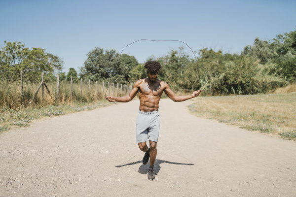 young man skipping rope during workout