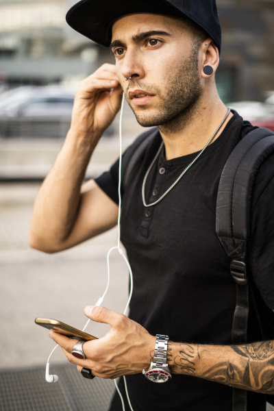 young man with earphones and smartphone