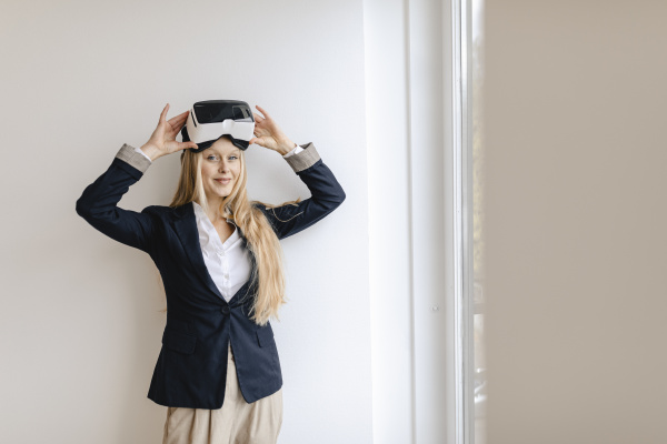 portrait of young businesswoman wearing vr