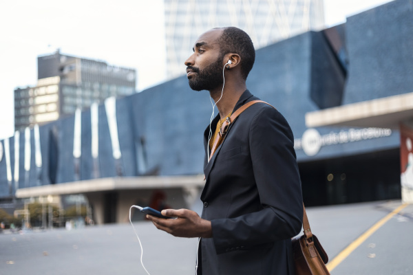 young businessman with listening music with