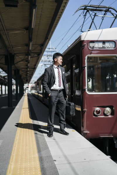 young businessman on a train platform