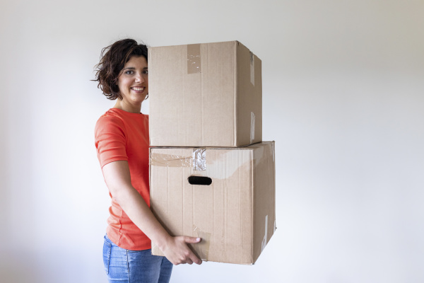 woman moving into new home carrying