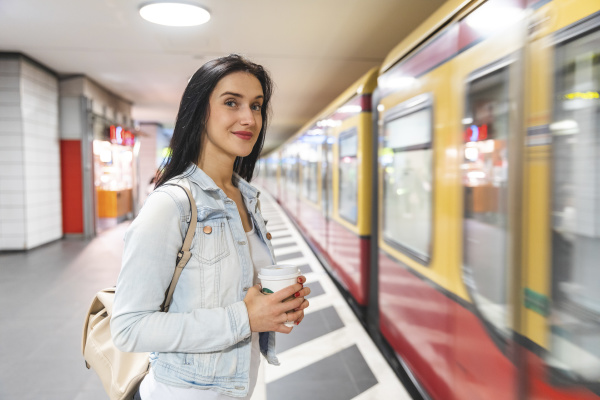young woman at metro station waiting