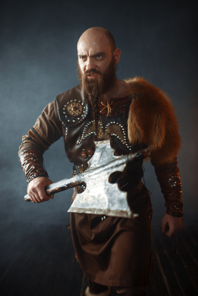 bearded viking with axe enters the