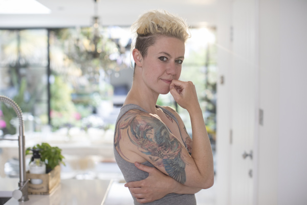 portrait confident woman with tattoos in