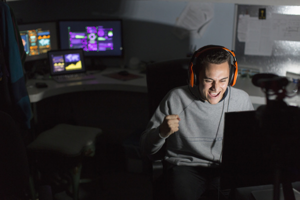 excited teenage boy with headset cheering