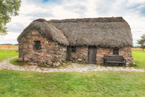 old scottish stone house with thatched