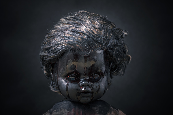 creepy bloody doll in the dark