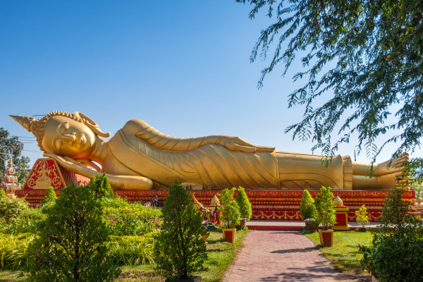 golden reclining buddha in gardens at