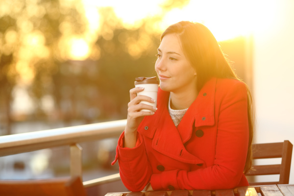 woman, holding, takeaway, coffee, at, sunset - 28278015