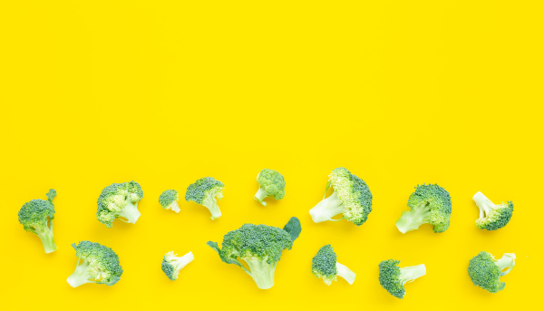fresh broccoli on yellow background