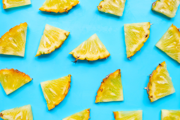 fresh pineapple slices on blue background