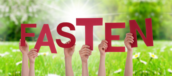 people-hands-holding-word-fasten-means-fasting-grass-stock-photo