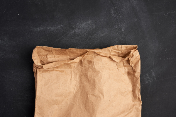 brown paper bag on a black