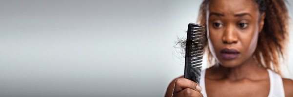 worried woman suffering from hairloss