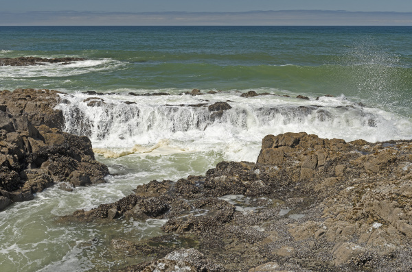 waves pouring over coastal rocks