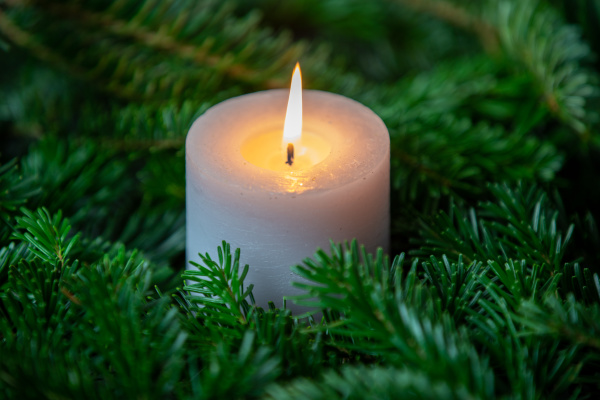 christmas motif with white burning candle