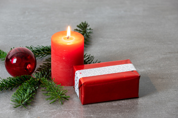 christmas motif with red burning candle